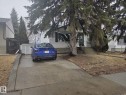 The property features a concrete driveway and a front yard with mature trees - 3626 111 Avenue, Edmonton, AB  - Outdoor 