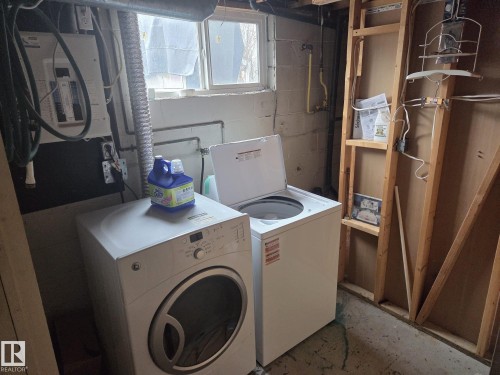 Utility area featuring a washer and dryer, a window, and exposed wall studs - 3626 111 Avenue, Edmonton, AB - Indoor Photo Showing Laundry Room