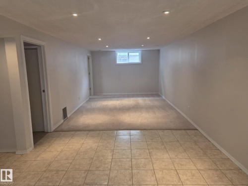 This versatile room features recessed lighting and a combination of tiled and carpeted flooring - 3626 111 Avenue, Edmonton, AB - Indoor