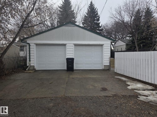 The property features a two-car garage with white paneled garage doors - 3626 111 Avenue, Edmonton, AB - Outdoor