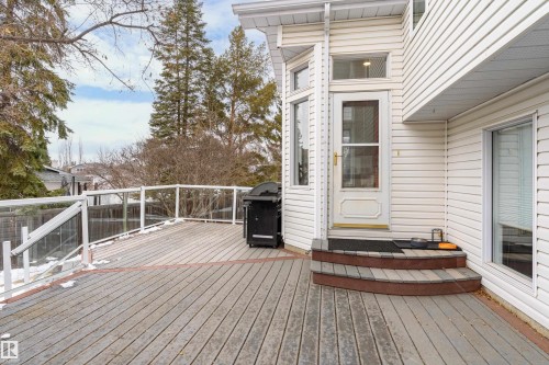 An expansive outdoor deck featuring composite decking and glass panel railings - 10 Harmony Place, St. Albert, AB - Outdoor With Deck Patio Veranda With Exterior
