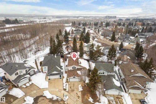 An aerial view showcasing the property situated within a residential area with other homes and trees - 10 Harmony Place, St. Albert, AB - Outdoor With View