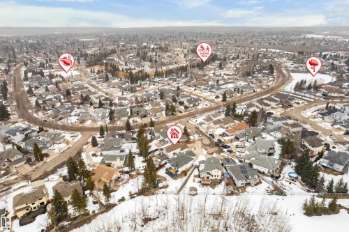 Aerial view of the surrounding neighbourhood, featuring residential properties, roads, and areas with trees - 10 Harmony Place, St. Albert, AB - Outdoor With View