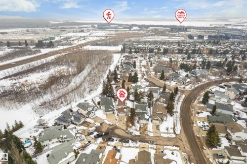 Aerial view of the neighborhood showing residential properties, roads, and surrounding natural areas - 10 Harmony Place, St. Albert, AB - Outdoor With View