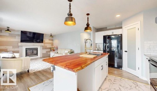 1315 Westerra Drive, Stony Plain, AB - Indoor Photo Showing Kitchen With Fireplace