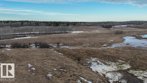Expansive undeveloped land featuring varied topography, natural wetlands, and a perimeter of mature trees - 57027 Sec Hwy 881, Rural St. Paul County, AB 