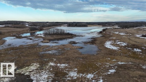 Expansive open land featuring natural water features, scattered trees, and undulating terrain - 57027 Sec Hwy 881, Rural St. Paul County, AB 