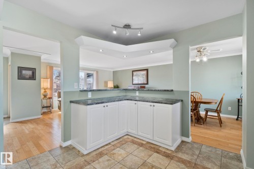 Spacious interior featuring a tiled floor, white cabinetry, and a dark countertop - 2016 138 Avenue, Edmonton, AB - Indoor