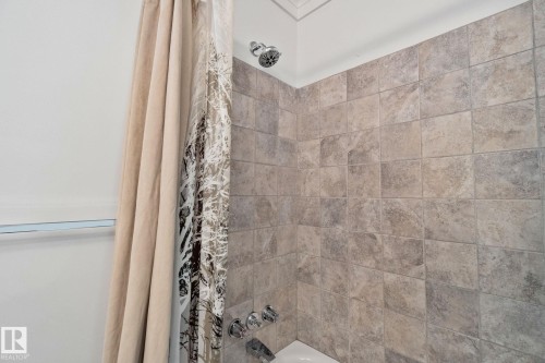 Bathroom featuring a tiled shower surround and a chrome showerhead and fixtures - 2016 138 Avenue, Edmonton, AB - Indoor Photo Showing Bathroom