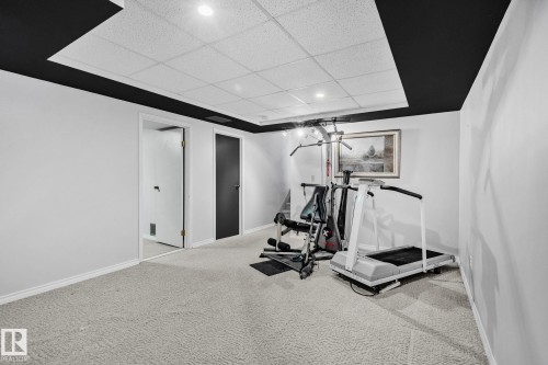 This versatile room features light-colored carpet flooring, white walls, and a ceiling with recessed lighting - 2016 138 Avenue, Edmonton, AB - Indoor Photo Showing Gym Room