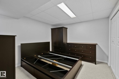 The room features light colored walls, a drop ceiling with a rectangular light fixture, and light colored carpeting - 2016 138 Avenue, Edmonton, AB - Indoor Photo Showing Other Room