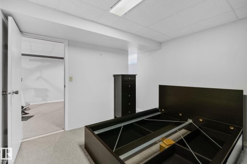 This room features light-colored carpeting, white walls, and a drop ceiling with recessed lighting - 2016 138 Avenue, Edmonton, AB - Indoor Photo Showing Other Room