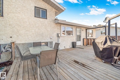 The property features a spacious wooden deck, ideal for outdoor entertaining - 2016 138 Avenue, Edmonton, AB - Outdoor With Deck Patio Veranda With Exterior