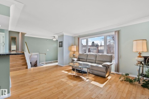 Bright living area featuring hardwood flooring and a large window providing natural light - 2016 138 Avenue, Edmonton, AB - Indoor Photo Showing Living Room