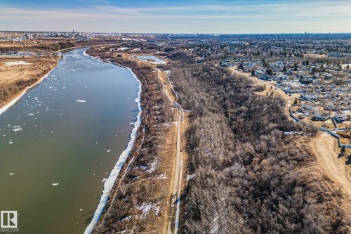 The property offers views of a river with ice, a wooded area, and distant residential areas - 2016 138 Avenue, Edmonton, AB - Outdoor With Body Of Water With View