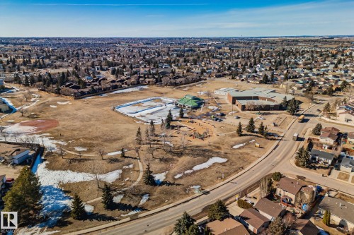 This aerial view showcases the property's advantageous location within a developed neighborhood, featuring surrounding residential properties and a visible road network - 2016 138 Avenue, Edmonton, AB - Outdoor With View