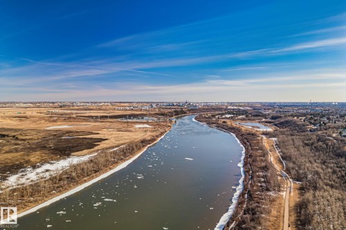Aerial view of the river, surrounded by bare trees and open land, under a clear blue sky - 2016 138 Avenue, Edmonton, AB - Outdoor With View