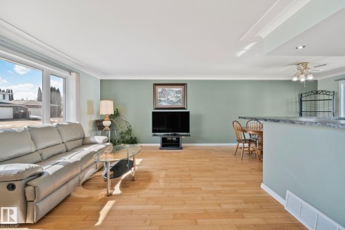 Living space featuring hardwood flooring, light green walls, and crown molding - 2016 138 Avenue, Edmonton, AB - Indoor Photo Showing Living Room