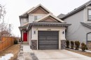 This property features a two-story exterior with light-colored siding and stone accents - 22742 95A Ave, Edmonton, AB  - Outdoor 