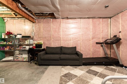 The property features an unfinished basement with exposed wooden joists and ductwork, providing potential for customization - 22742 95A Ave, Edmonton, AB - Indoor Photo Showing Basement