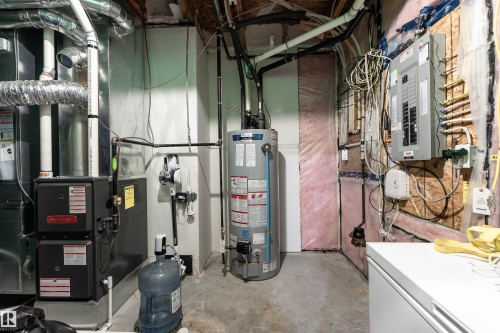 The property features a utility room with a water heater, furnace, and electrical panel - 22742 95A Ave, Edmonton, AB - Indoor Photo Showing Basement