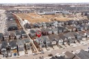 Aerial view of the property and surrounding neighborhood, featuring residential streets, houses with various rooflines, and open land - 22742 95A Ave, Edmonton, AB  - Outdoor With View 