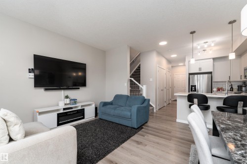 An open-concept living area featuring light-toned walls, recessed lighting, and light wood flooring - 22742 95A Ave, Edmonton, AB - Indoor Photo Showing Living Room