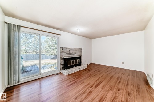 12054 25 Avenue, Edmonton, AB - Indoor Photo Showing Living Room With Fireplace