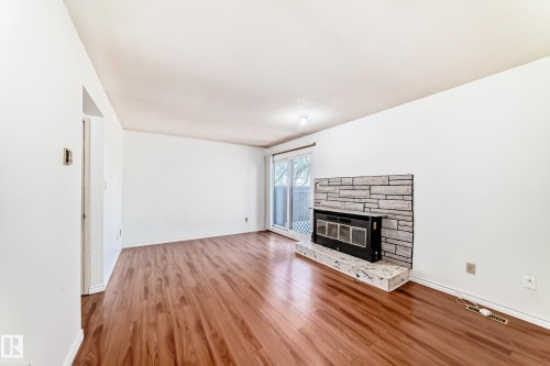 12054 25 Avenue, Edmonton, AB - Indoor Photo Showing Living Room With Fireplace