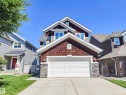 The property features a two-car garage, a concrete driveway, and a well-maintained lawn - 8008 18 Avenue Sw, Edmonton, AB  - Outdoor 