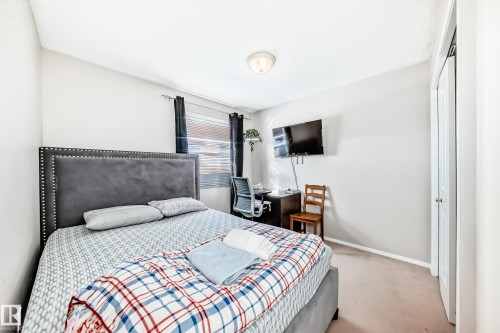 This room features light-colored walls and carpeted flooring, with a window providing natural light - 19024 50 Avenue, Edmonton, AB - Indoor Photo Showing Bedroom