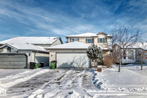 The property features a two-story design with a two-car garage and a paved driveway - 19024 50 Avenue, Edmonton, AB - Outdoor With Facade