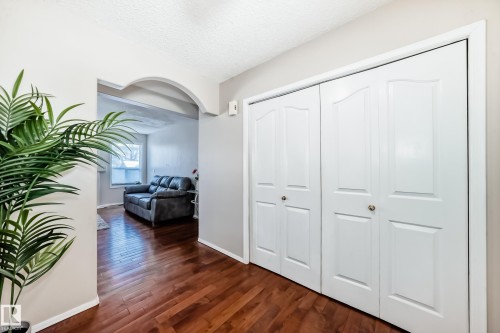 The property features rich hardwood flooring and a functional storage closet with white paneled doors - 19024 50 Avenue, Edmonton, AB - Indoor