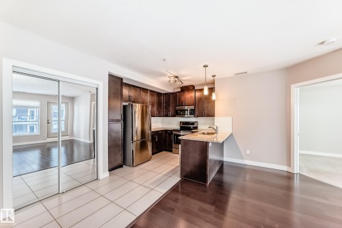 711 5151 Windermere Boulevard, Edmonton, AB - Indoor Photo Showing Kitchen With Stainless Steel Kitchen
