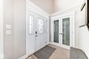 The property features a white front door with decorative glass inserts and sidelights - 4134 Charles Link, Edmonton, AB  - Indoor Photo Showing Other Room 