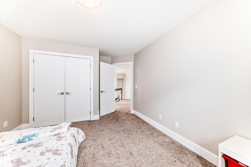 The property features light-colored walls and soft carpet flooring, creating a comfortable ambiance - 4134 Charles Link, Edmonton, AB - Indoor Photo Showing Bedroom