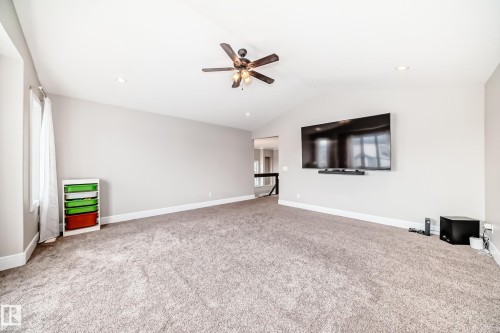 The living area features vaulted ceilings, recessed lighting, and a ceiling fan - 4134 Charles Link, Edmonton, AB - Indoor