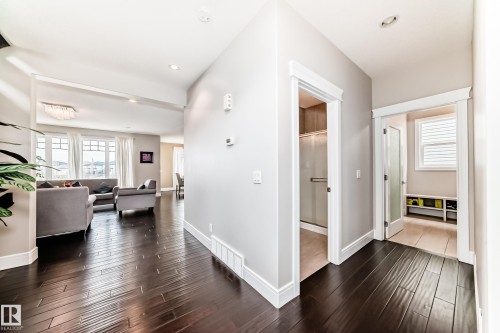 The property features dark hardwood flooring throughout, light grey walls, and white trim - 4134 Charles Link, Edmonton, AB - Indoor