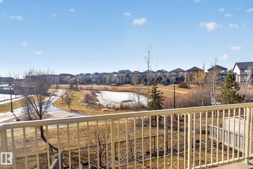 The property offers views of a paved pathway, a pond, and residential homes in the distance - 4134 Charles Link, Edmonton, AB - Outdoor With View