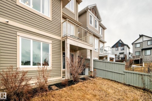 Exterior view of the property featuring horizontal siding and white-framed windows - 4134 Charles Link, Edmonton, AB - Outdoor