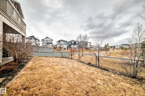 The property features a private yard with a wooden fence and a chain-link fence, providing a clear view of the surrounding landscape - 4134 Charles Link, Edmonton, AB - Outdoor