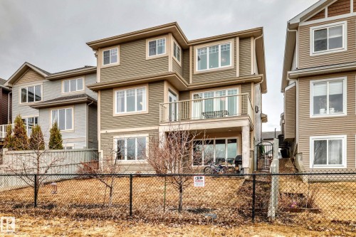 The property features an exterior with horizontal siding and prominent white-framed windows - 4134 Charles Link, Edmonton, AB - Outdoor With Facade