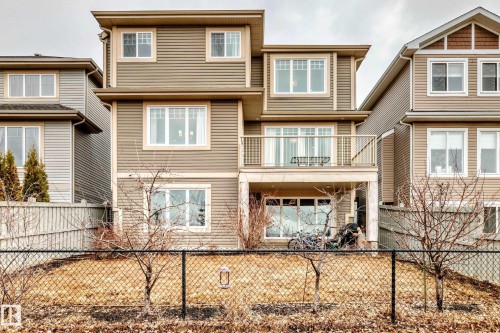 The property features multi-level construction with horizontal siding and multiple windows, including several large picture windows - 4134 Charles Link, Edmonton, AB - Outdoor With Facade