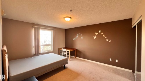 The room features a window with vertical blinds, providing natural light - 1318 330 Clareview Station Drive Nw, Edmonton, AB - Indoor Photo Showing Bedroom