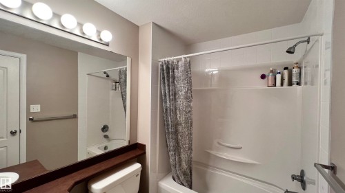 Bathroom featuring a shower and bathtub combination with a shower curtain - 1318 330 Clareview Station Drive Nw, Edmonton, AB - Indoor Photo Showing Bathroom