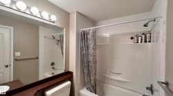 Bathroom featuring a shower and bathtub combination with a shower curtain - 