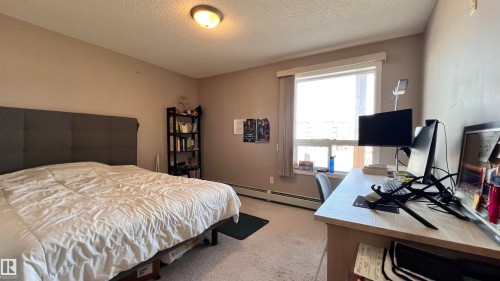 This room features a window with blinds, carpeted flooring, and a ceiling light fixture - 1318 330 Clareview Station Drive Nw, Edmonton, AB - Indoor Photo Showing Bedroom