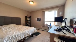 This room features a window with blinds, carpeted flooring, and a ceiling light fixture - 