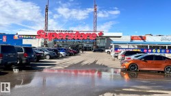 The property is located within a commercial plaza featuring a large retail store and a medical clinic - 