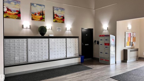 The property features a well-maintained entry area with individual mailboxes and package lockers - 1318 330 Clareview Station Drive Nw, Edmonton, AB - Indoor Photo Showing Other Room